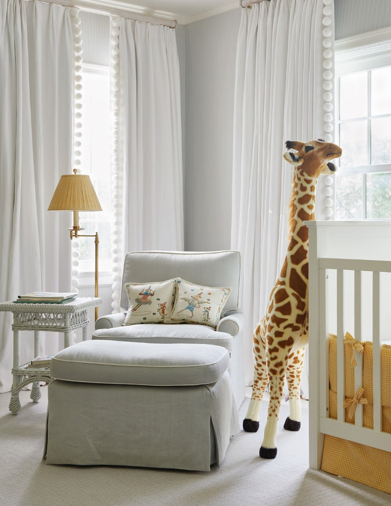 Lounge chair in nursery with stuffed giraffe