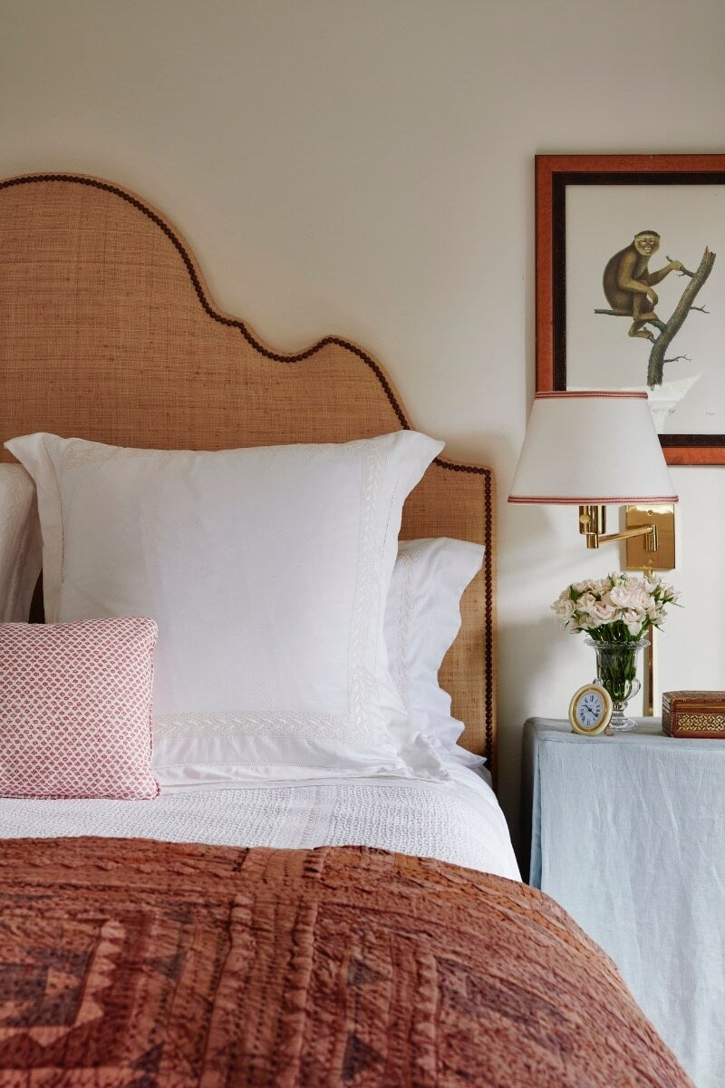 Detail shot of bed with white pillows and brown throw