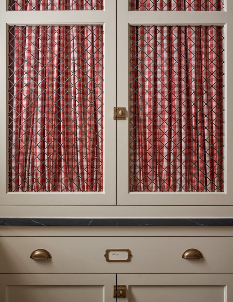 Cupboard with red gingham fabric