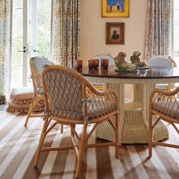 Side view of cane chairs and woven dining table