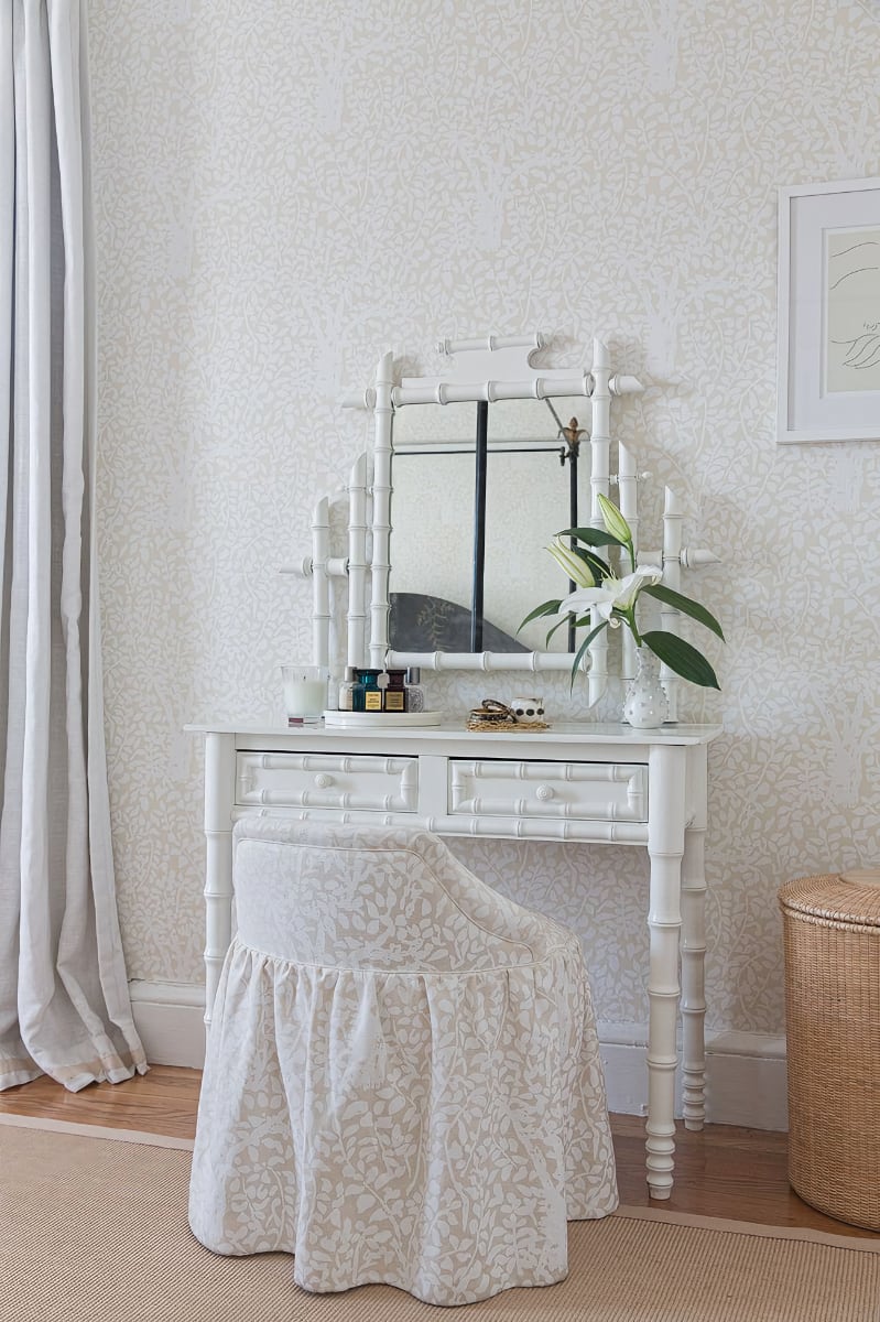 White bamboo desk with draped fabric chair