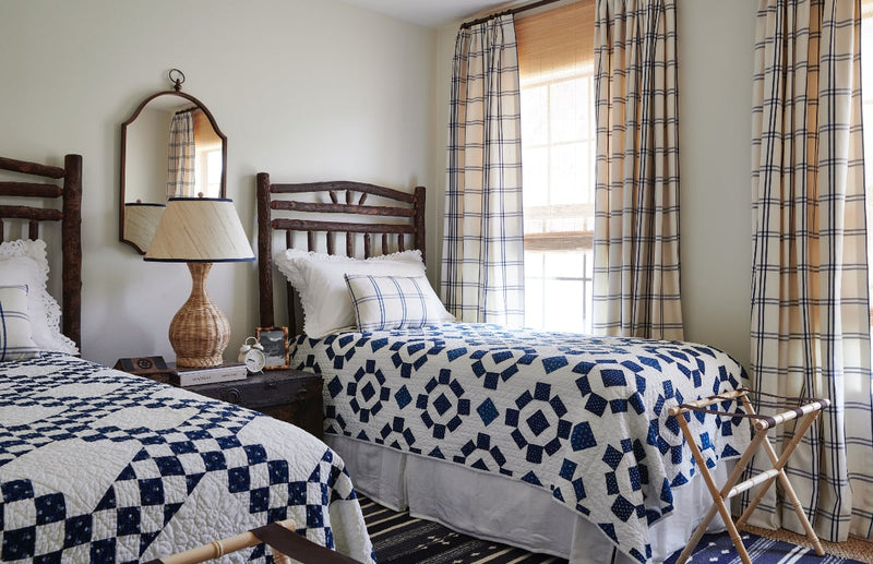 Twin beds with blue and white patterned quilts