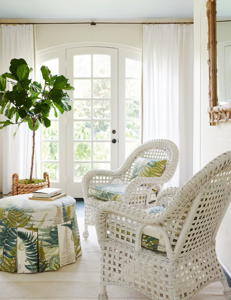 Sun room seating area with woven lounge chairs