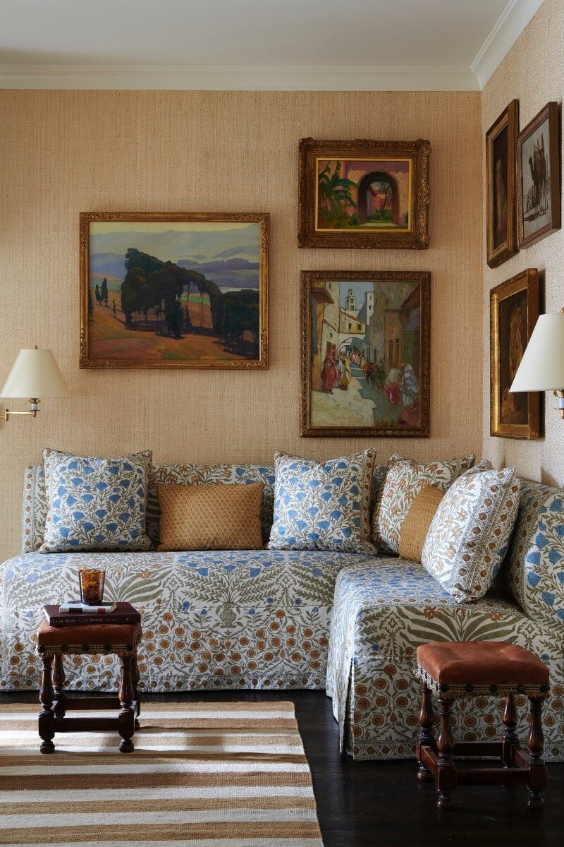 Sofa with patterned upholstery and art on covered walls