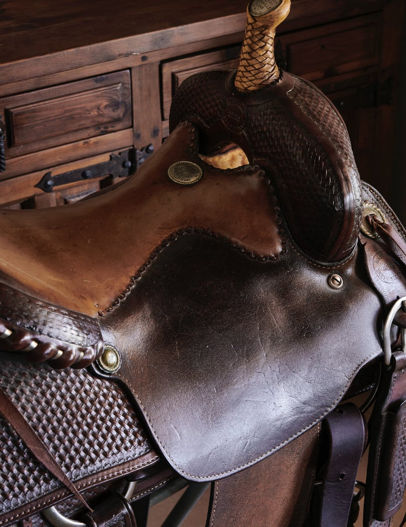 Closeup photo of saddle on display