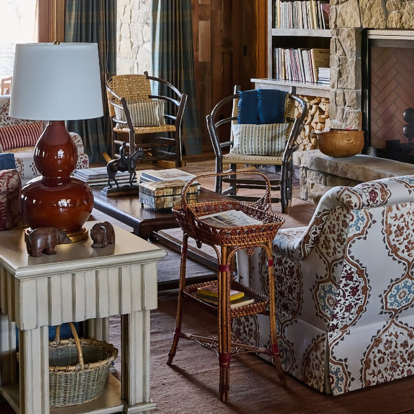 Living room with blue sofa, lounge chairs, a fireplace.